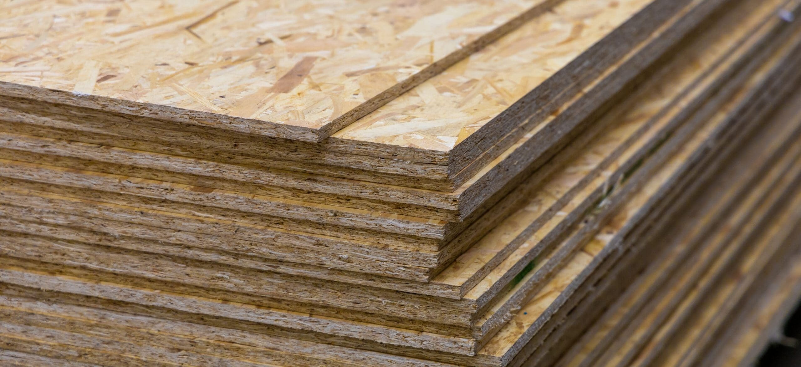 OSB Oriented Strand Board. Sheet stack in a construction store. Engineered wood product for load bearing applications in construction